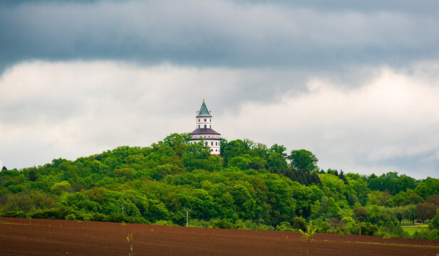 Humprecht Castle in Sobotka, Cesky Raj, rises above forests and fields under dramatic dark clouds. Baroque tower-like shape 17th century hunting lodge now museum and concert hall