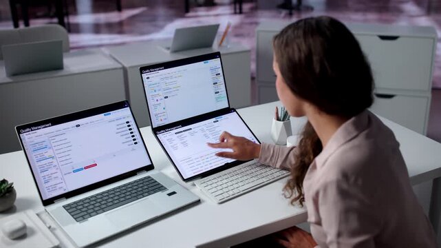 Quality Manager Reviews Corrective Action Reports On Laptop