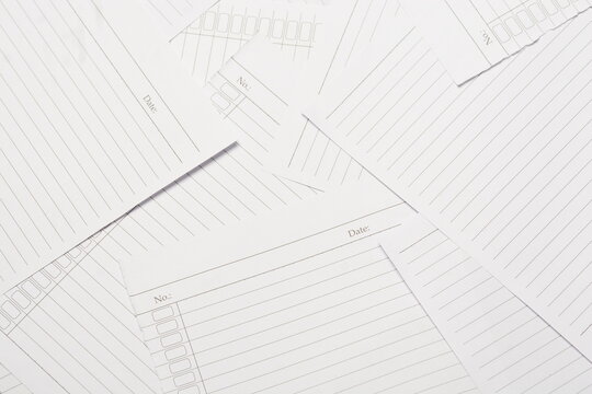 Full frame of scattered blank lined notebook papers background