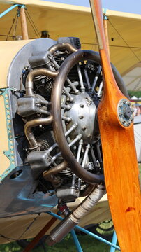 View of a vintage radial aircraft engine and a polished wooden propeller on a classic biplane at La Ferte-Alais, Ile-de-France, France.