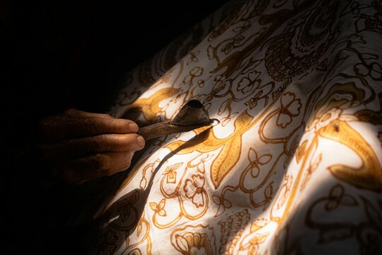 Batik craft creation with Canting by Artisan creates Traditional intricate design for Indonesian cultural heritage documentation