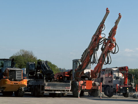 View of heavy hydraulic drilling rigs and construction machinery parked at a site under a clear blue sky Sariyer, Istanbul, Turkiye.