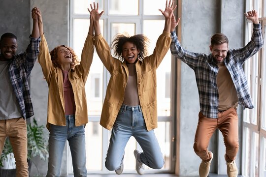 Team success winners, hi five or congratulation on business goal achievement, collaboration or encouragement concept, happy businessman and woman teamwork coworkers jumping and hi five clapping hands.