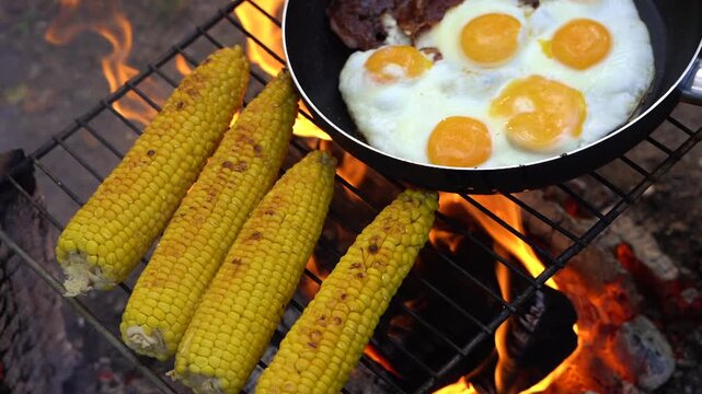 Grilled dishes evoke rustic atmosphere. Charred vegetables and sizzling eggs produce inviting scents. Al fresco food preparation offers charming rustic flavors and appetizing aromas