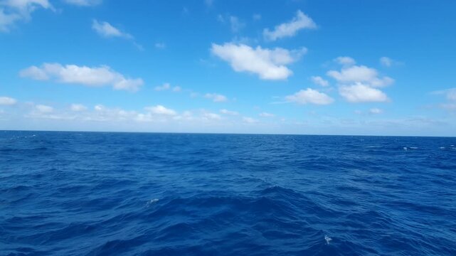 various shapes of clouds in the sky above the choppy sea