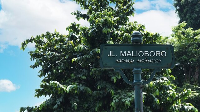 Malioboro street sign in Yogyakarta city center provides travel landmark for Indonesia tourism and urban navigation concept