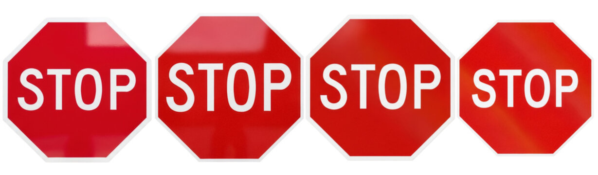 A row of four distinct red stop signs, each with white lettering, isolated on a transparent background.
