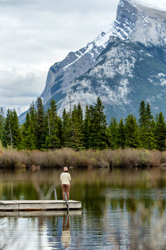 Woman standing on dock at Vermilion Lakes view in Banff National Park