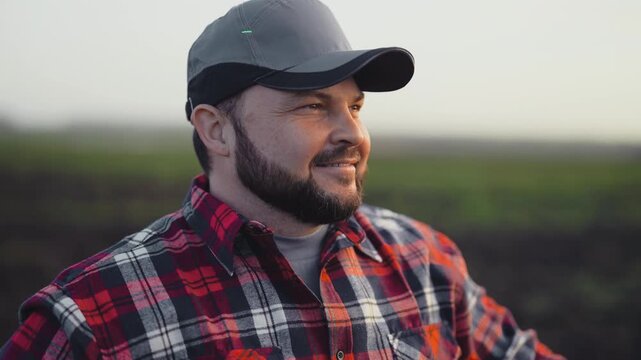 Happy farmworker admiring beautiful landscape in agricultural region, rural life. Successful farmer rejoicing by good harvest in farmland, organic farming and agribusiness, modern farm technology