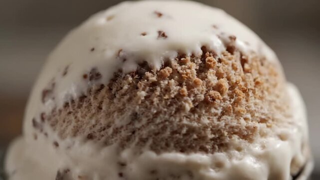 Extreme macro close-up of creamy vanilla ice cream scoop with chocolate speckles and swirls, showing rich texture, refreshing dessert, and sweet cold treat detail.