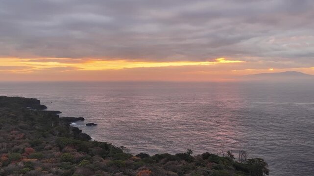 Aerial rising view of purple morning sea and Jogasaki Coast with Izu Oshima Japan