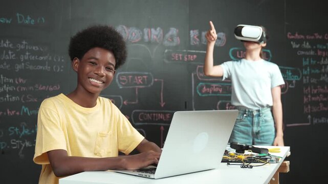 Smart african student programming and coding innovative system while caucasian girl enter in metaverse or virtual world by using VR or head set at blackboard in STEM technology classroom. Edification