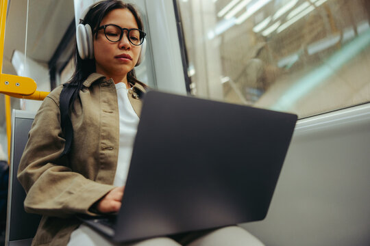 Commuter working on laptop during a train commute