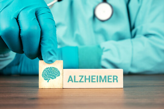 Concept of the central nervous system, neurological assessment, and prevention of neurodegenerative diseases. Alzheimer's. The doctor's hand arranges wooden cubes with brain icons.