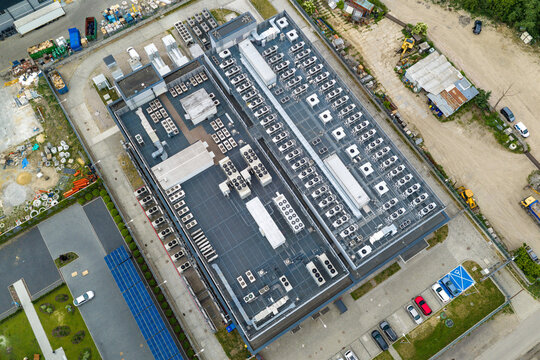 Aerial view of the hyper scale data center building featuring numerous HVAC units and cooling systems in Warszawa, Wojewodztwo mazowieckie, Poland.