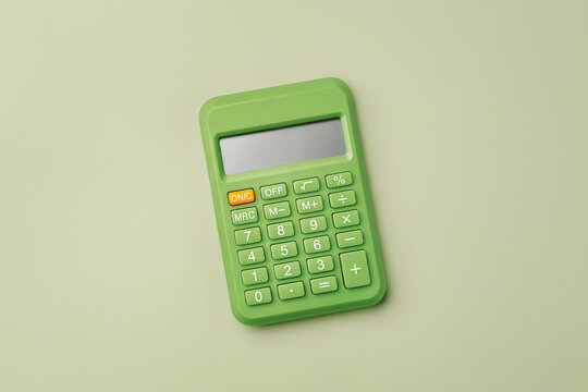 Top view of Green calculator on a pastel green background