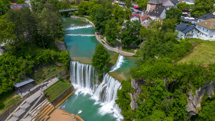 Fototapeta premium Aerial panoramic view of beautiful Pliva waterfall and medieval old town castle in Jajce, Bosnia and Herzegovina
