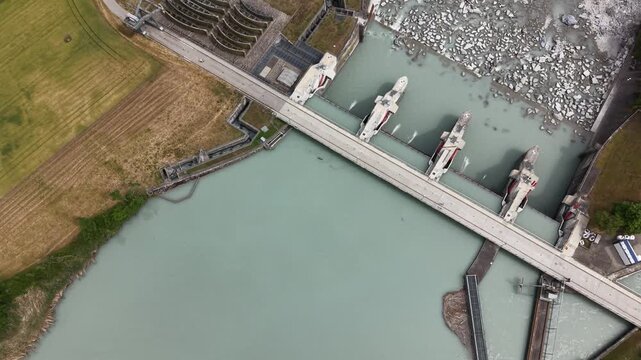 Drone footage crossing a hydroelectric dam and revealing downstream water distribution structures and engineering systems