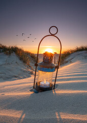 romantic lantern with candle on the beach in sunset light © Jenny Sturm