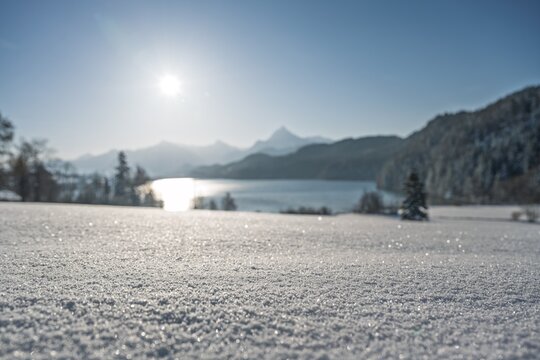 Beautiful Alpine Lake in Winter Covered with Snow at Sunny Day, Idyllic Frozen Mountain Lake with Sparkling Snowfield and Majestic Peaks, Scenic Cold Wilderness Landscape