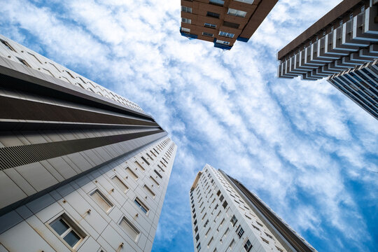 Looking upward, towers and highrise apartments pull a lowangle view through Benidorm, Spain, where sky architecture and tourism facades converge