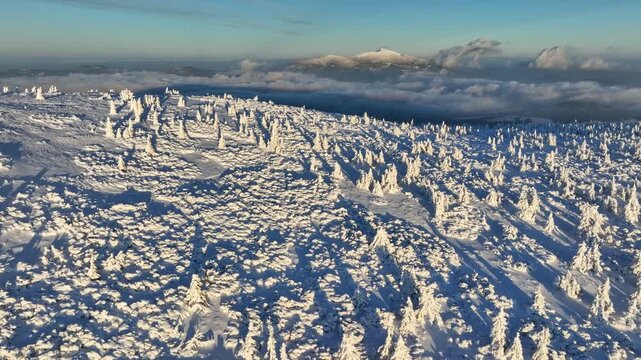 Dynamic aerial lift and pan over winter Pilsko peak with Babia Gora in background