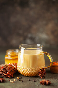 Golden Cinnamon  Turmeric Milk. Trendy hot Healthy drink with turmeric roots and spices. Indian Masala Haldi Doodh.