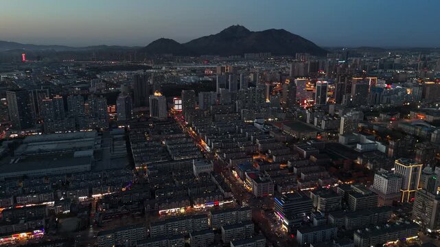 Cinematic Sunset Over Dalian Skyline in North China, Golden City Lights and Coastal Urban View