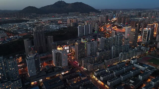 Cinematic Sunset Over Dalian Skyline in North China, Golden City Lights and Coastal Urban View