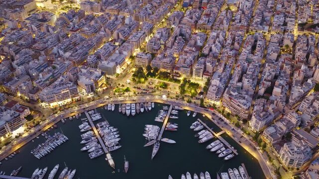 Luminous aerial perspective capturing the mesmerizing beauty of zea marina in piraeus, greece, as the drone flies over the illuminated cityscape and yachts moored in the harbor at twilight