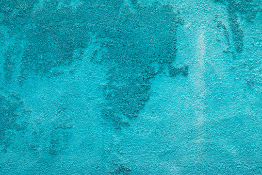Abstract grunge turquoise plaster background with rough sand texture