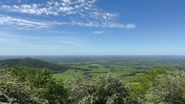 Sutton Bank Finest View in England viewpoint in Northern England over North Yorkshire countryside beneath a blue sky.