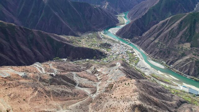 Drone view of winding road on Muma mountains in Jinchuan country, Aba Tibetan and Qiang Autonomous Prefecture, Sichuan, China. 4k real time top down footage, travel concept.