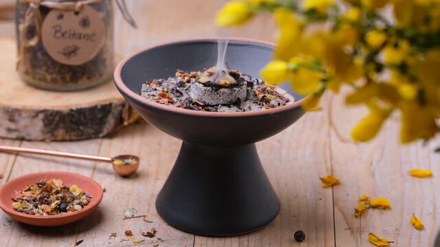 Beltane incense ritual with frankincense, resins and dried herbs, static shot