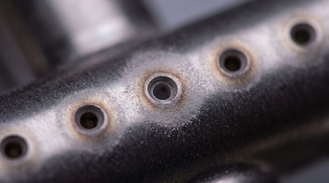Macro detail of a metal gas distribution manifold with precision orifices for semiconductor fabrication equipment