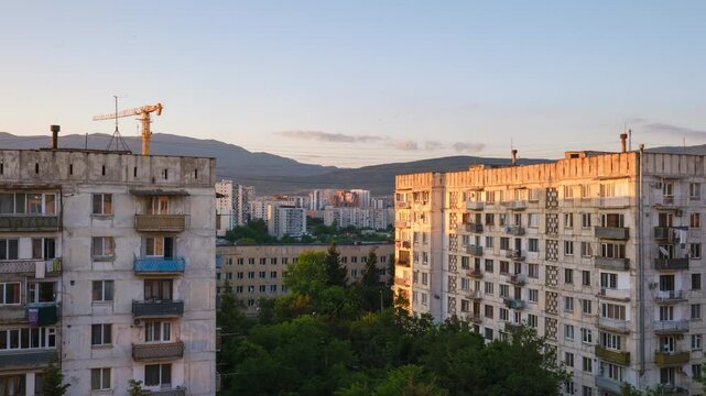 Static urban timelapse capturing twilight falling over a residential district in Mukhiani, Tbilisi, showcasing post-Soviet style apartment blocks