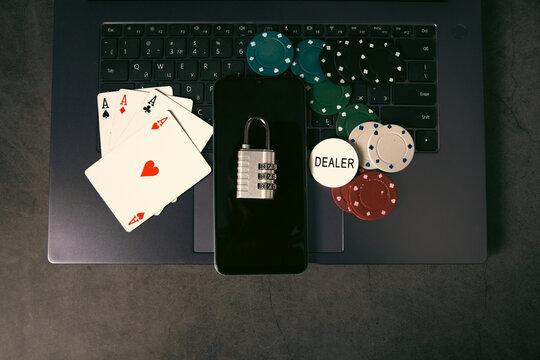 Laptop with a lock and poker chips. Online gambling concept.
