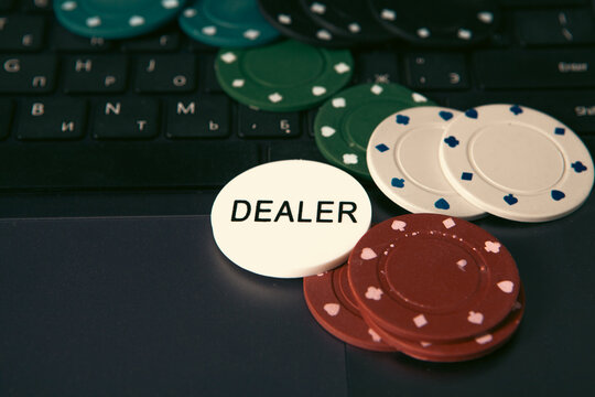 Poker chips and cards on the laptop keyboard. Online casino concept