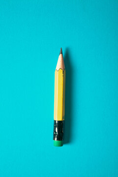 Yellow pencil on a blue background. Back to school. Copy space.