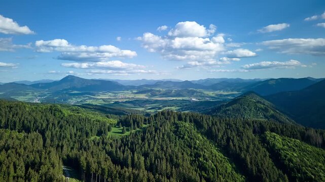Aerial Hyperlapse Flying Sideways Revealing Vast Carpathian Mountain Panorama with Green Valley and Blue Sky