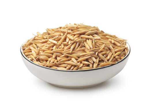 Whole oat grains in ceramic bowl