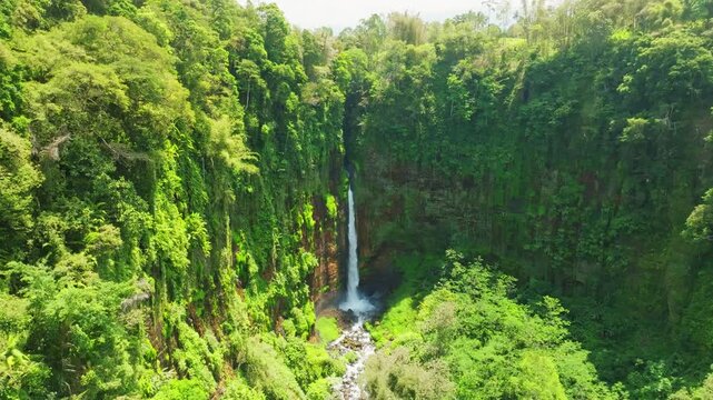 Amazing Beautiful waterfall in tropical rainforest in national park at East Java, Indonesia