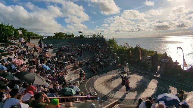 Bali Indonesia, 15 December 2025 : Kecak Bali Culture. Traditional Balinese Kecak Dance at Uluwatu Temple in golden Sunset. View from beutiful clifftop Uluwatu temple in Bali of warm vibrant sunset ov
