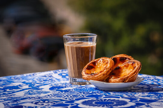 Portuguese Custard Tarts Coffee and Pastel de Nata on Blue Table