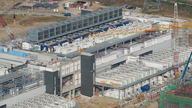 Aerial drone view of a massive hyperscale data center under construction in Chonburi, Thailand, showing cloud infrastructure, AI computing and industrial scale digital growth.