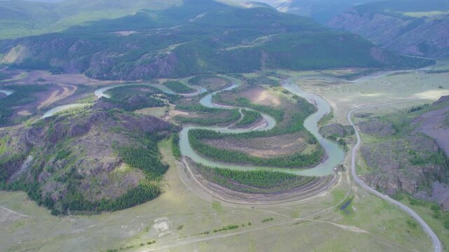 Aerial view of winding river through green valley