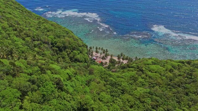 Drone view of Playa Fronton beach in Las Galeras Samana, Dominian Republic, flying swooping down