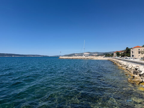 Coastal waterfront with clear blue sea and traditional architecture