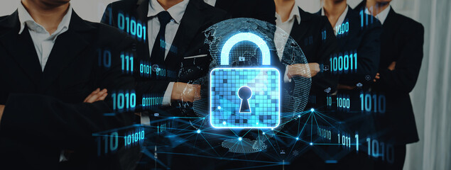 A business team stands united with a digital lock overlay symbolizing their commitment to cybersecurity solutions and data protection strategies in today tech-driven environment. Trope © InfiniteFlow