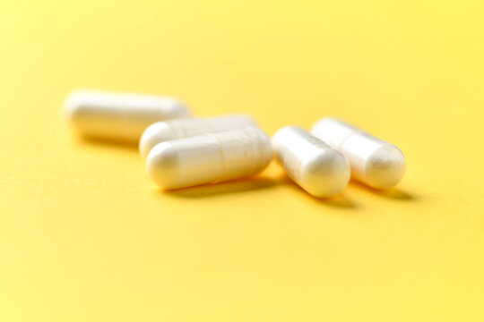 Zinc capsules on bright paper background. Soft focus. Close up. Copy space.
